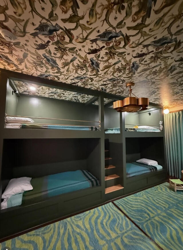 Reimagine your bonus room. We converted ours into a bunk room for our precious grandchildren. Use of fun colors and vibrant wallpaper on the ceiling adds interest and a sense of adventure.